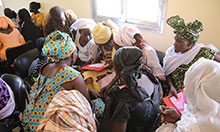 Members of a hygiene monitoring unit in Keur Socé, in Kaolack Department work on their action-plan to for how they will monitor hygiene in their communities. 