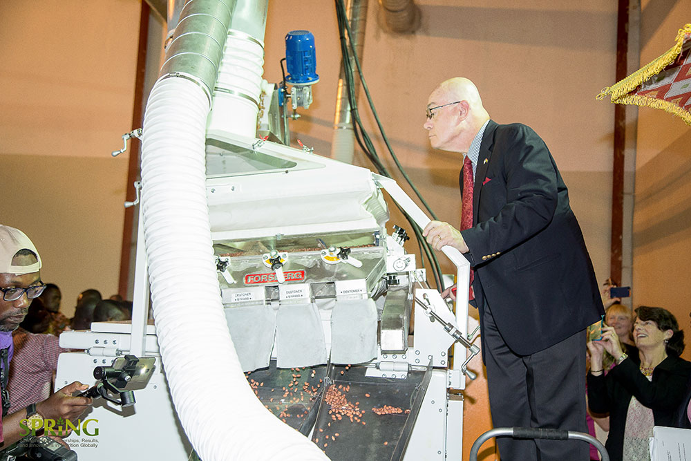 U.S. Ambassador Jackson taking a close look at how the nut roasting equipment operates.