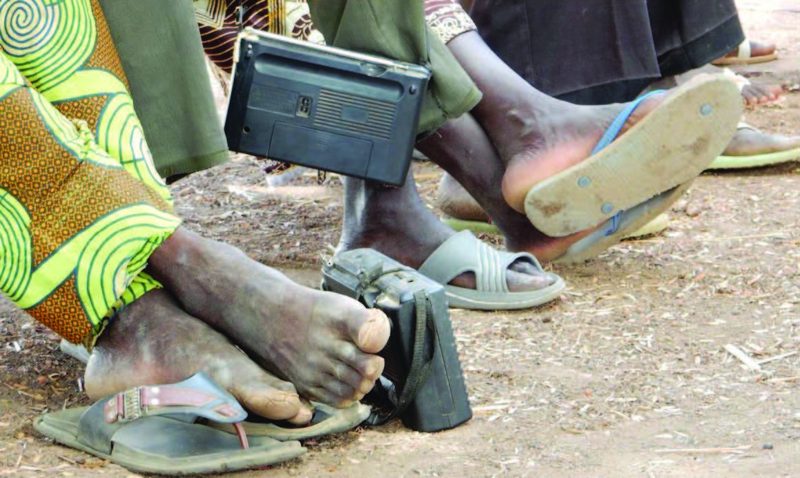 Close up image of camera resting at someone's feet. 