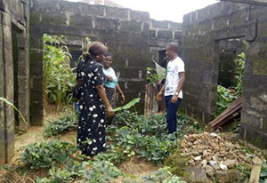SPRING Nutrition Coordinator Grace Essien visits a household vegetable garden in Ebom, Nigeria, where residents believed they could not grow their own food.