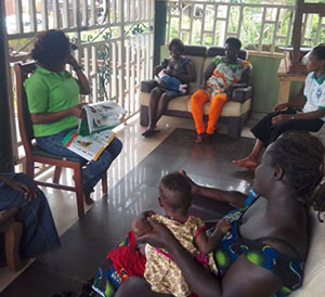 A nutrition officer meets with local mothers to discuss optimal feeding practices.