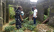 SPRING Nutrition Coordinator Grace Essien visits a household vegetable garden in Ebom, Nigeria, where residents believed they could not grow their own food.