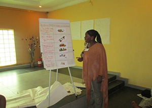Photo of Priscilla making a presentation during her training