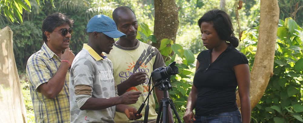 Group of people setting up a camera with a forest in the background.
