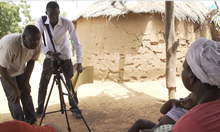 Videographers film a woman and her child