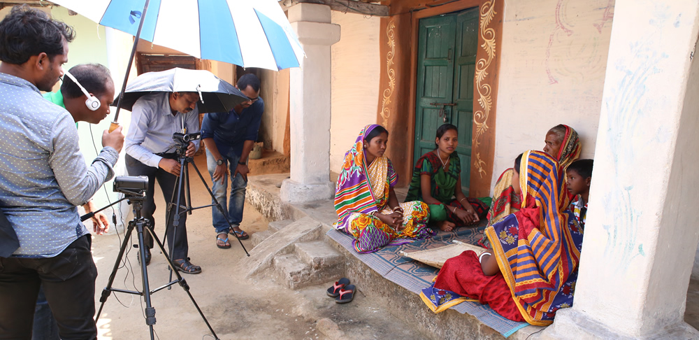 Filming a group of women practicing healthy food preparation