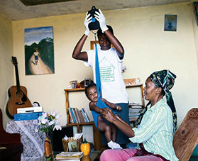 A health worker weighs a baby