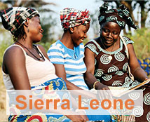 Three women smile together in Sierra Leone.