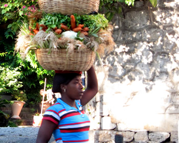Haitian woman carrying food