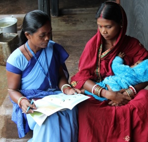 Photo of a new mother receiving counseling on breastfeeding her infant.