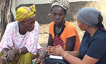 Cécile Ndiaye (right) speaks with two training participants.