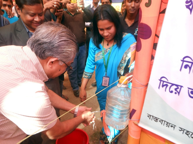 The Honorable State Minister washed his hands using a tippy tap installed by and promoted by SPRING