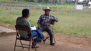 two men sitting and talking