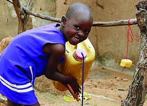a young girl washing her hands