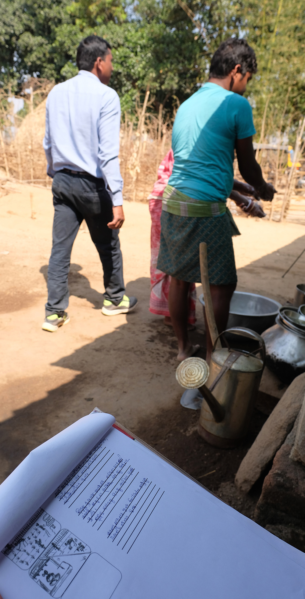 An outline of the story shows how the video was planned to demonstrate the grandmother and father washing hands to avoid illness after working in the garden with compost. In the background, the father and grandmother wash their hands. Photo credit: Sarah Hogan, 2017