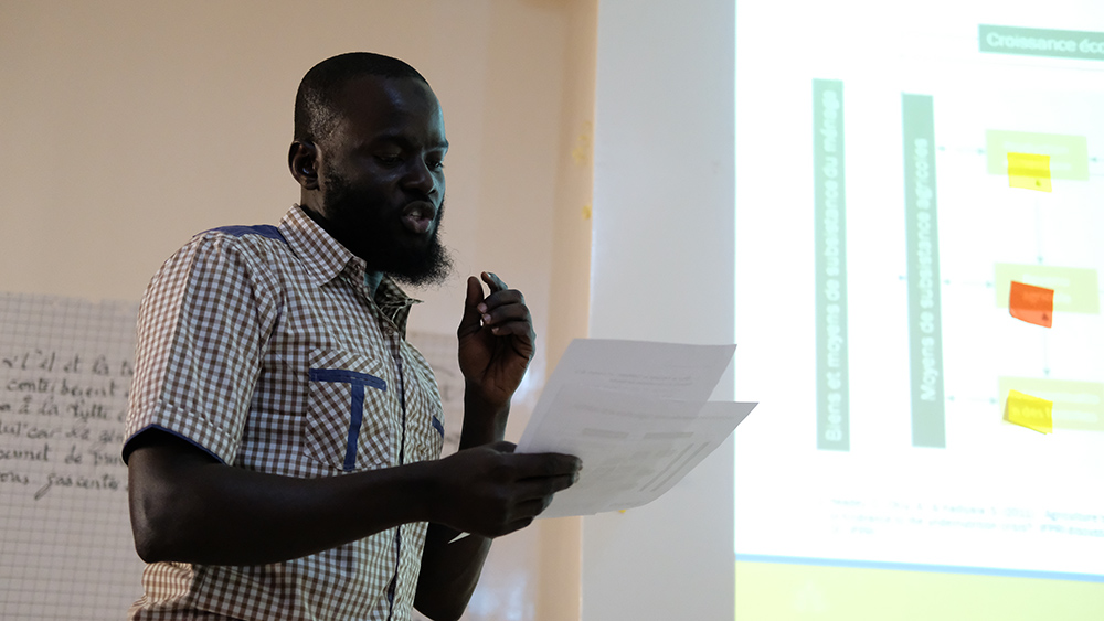 Peace Corps agriculture trainer, Maharmeth, presents his group’s case study on the agricultural income pathway. 
