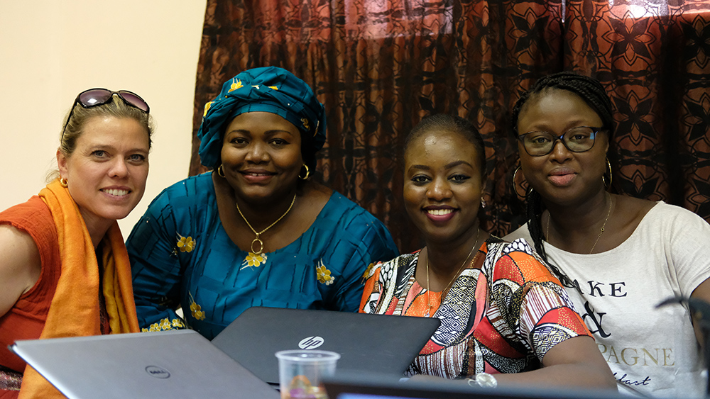 Nathalie of SPRING, and Nafi, Fatou, and Suzanne of KAWOLOR pause from discussing the training to pose for a photo together. 