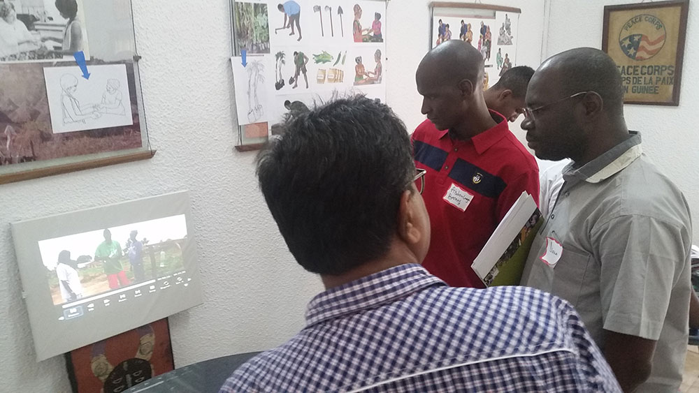 Digital Green's Dr. Nadagouda shares community video details to U.S. Peace Corps Guinea staff members N'Tossama Diarra and Dr Abdoulaye Barry.