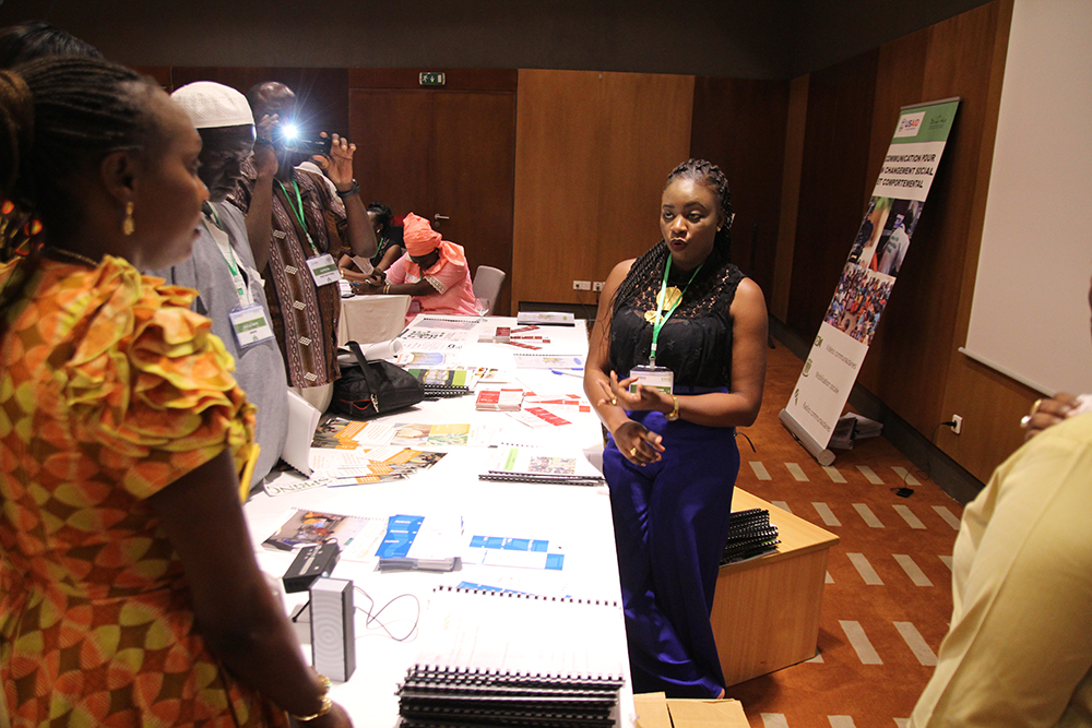 One of SPRING/Senegal’s department coordinators, Fatou Kiné Camara, speaks to guests about SPRING’s accomplishments in SBCC at one of the stands set up to showcase the projects achievements.