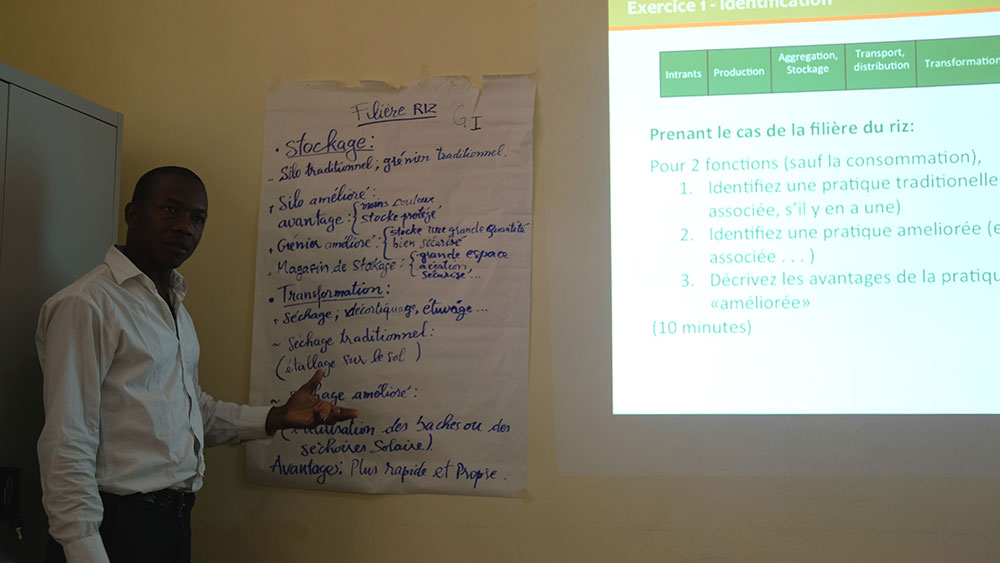 A staff participant explains his group’s ideas about the advantages of improved technologies within the rice value chain.