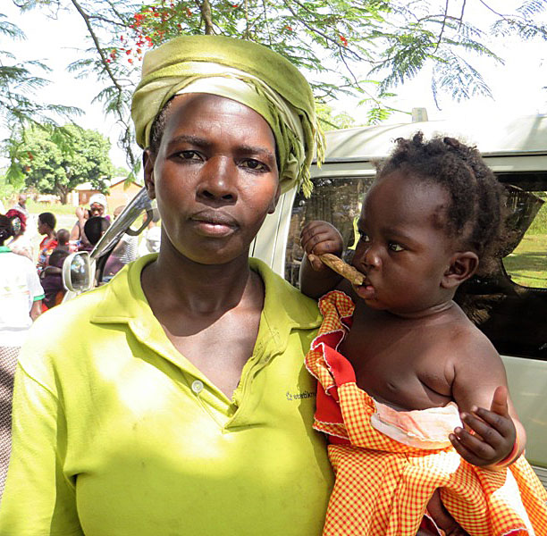 Rose Namukose, a beneficiary of the MNP program, shows off the baby who she has successfully enrolled