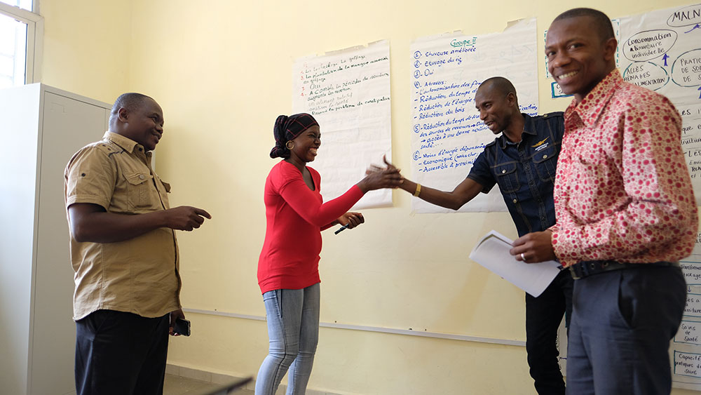 Staff participants conduct a role play, persuading each other to purchase their improved technology for making agriculture more nutrition sensitive.