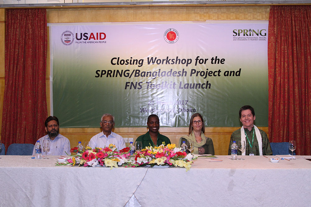 Deputy Program Manager of Community Based Health Care, Dr. Jahangir Rashid; Line Director of the National Nutrition Services, Dr. A.B.M. Muzharul Islam; Dr. Altrena Mukuria, Director of Country Initiatives for SPRING; Ms. Miranda Beckman, Acting Director of the Office of Population, Health, Education and Nutrition for USAID/Bangladesh; and the Chief of Party for SPRING/Bangladesh, Mr. Aaron Hawkins, sit on the dais after giving closing remarks at the closing workshop.