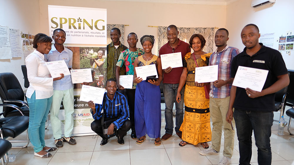 All of the workshop participants display their completion certificates. 