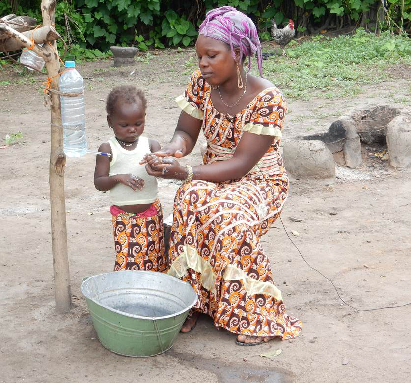 This community star demonstrates the proper handwashing procedure for herself and her child.