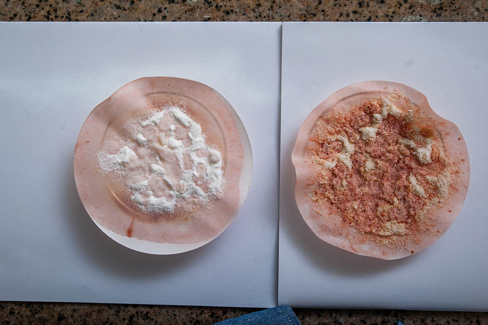 Fortified maize flour looks red/maroon upon testing (as seen on the right), unlike unfortified maize flour, which will have a slight hint of red/maroon (as seen on the left).  