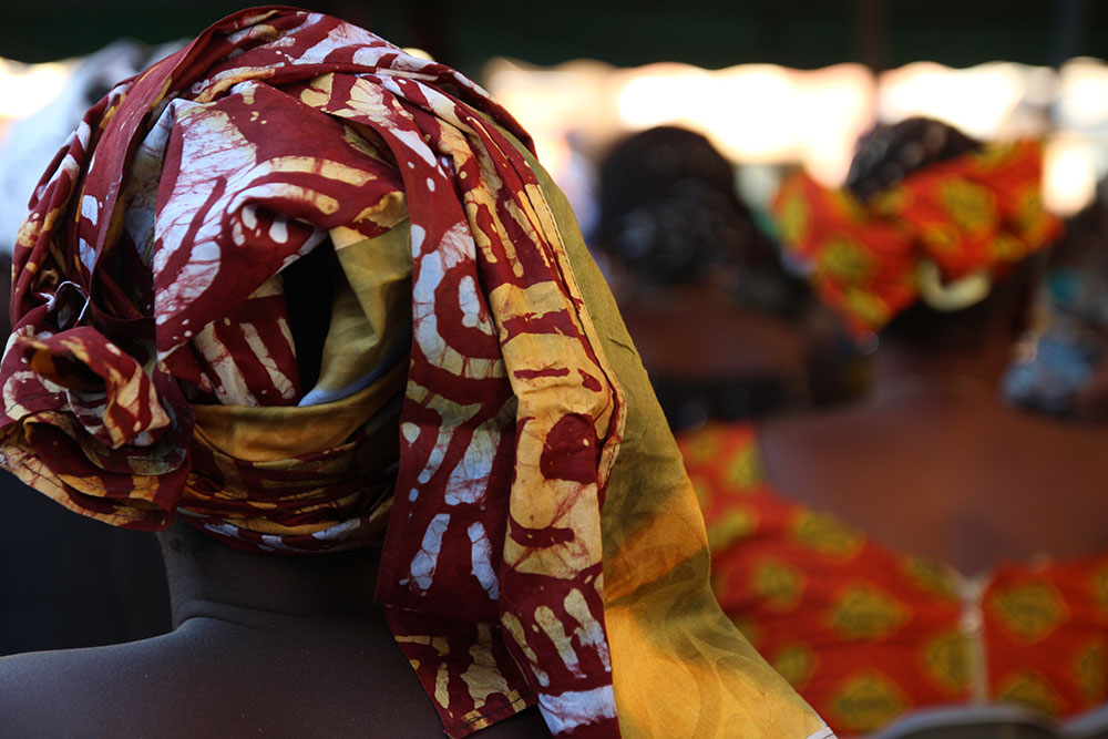 A woman looks on during the Malaria Day events in Dinguiraye.