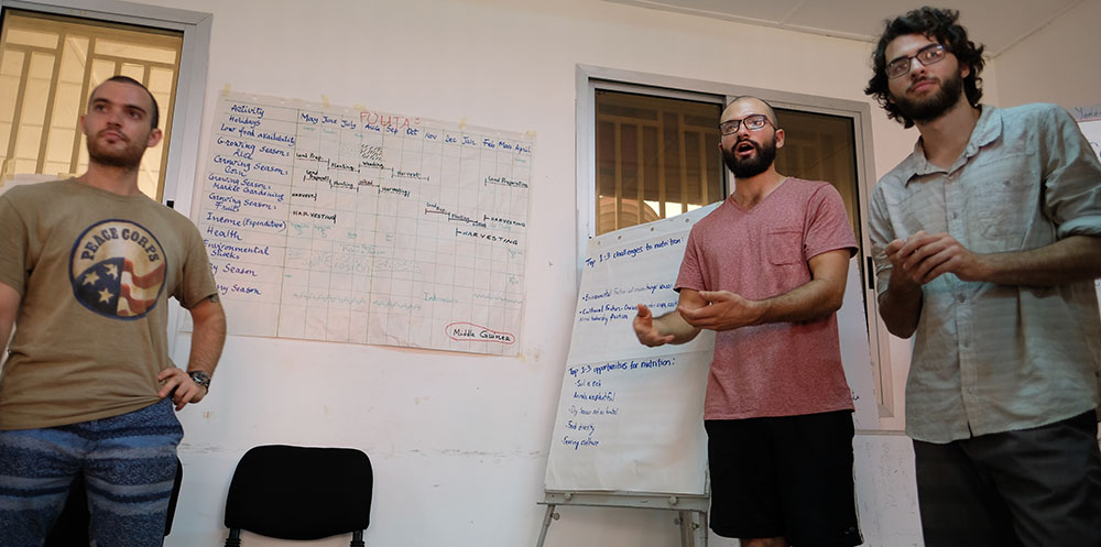 Peace Corps volunteers Alex, Lowell, and Eric, present their work identifying challenges and opportunities to nutrition throughout the year in the Fouta area of Guinea.