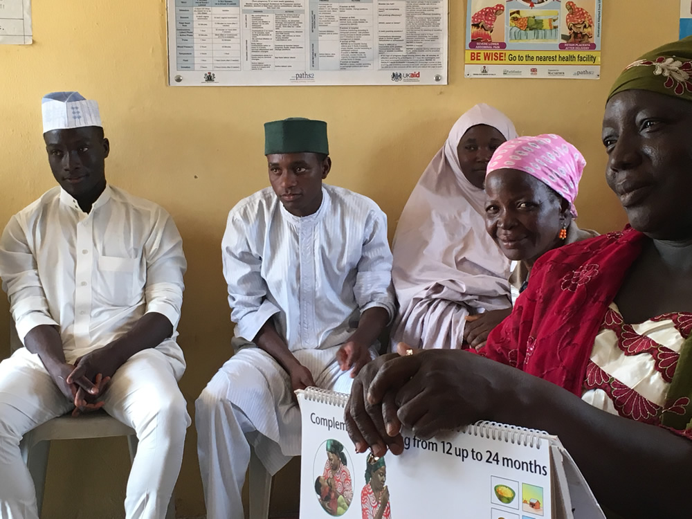Community Volunteers (CVs) from Kajuru ward in Kajuru LGA, including these men from Ruga Ardo Suleiman Community, a Fulani settlement, attend a monthly review meeting. During this meeting CVs shared stories of women struggling to deliver the placenta after birth and successfully doing so after the CVs encouraged the mother to breastfeed immediately. Several CVs also mentioned different endeavors of support groups to encourage new practices, save money, and even make money.