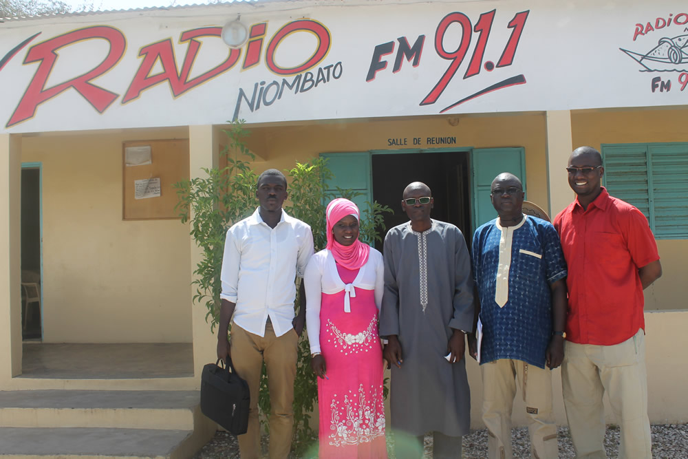 The SPRING/Senegal team poses in front of Radio Niombata in Toubakouta.