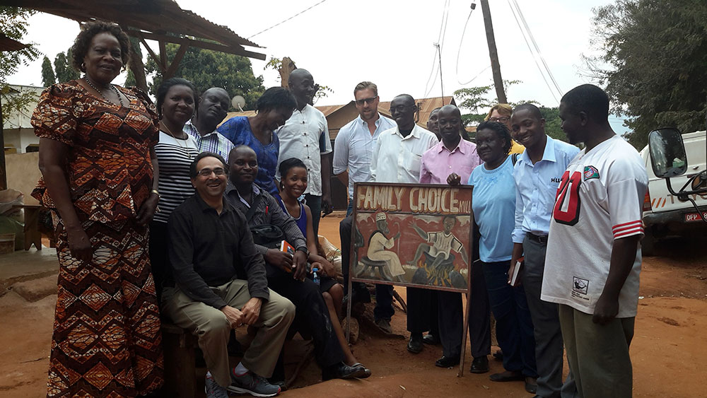 Participants pose for a group picture outside the Family Choice Maize Mill
