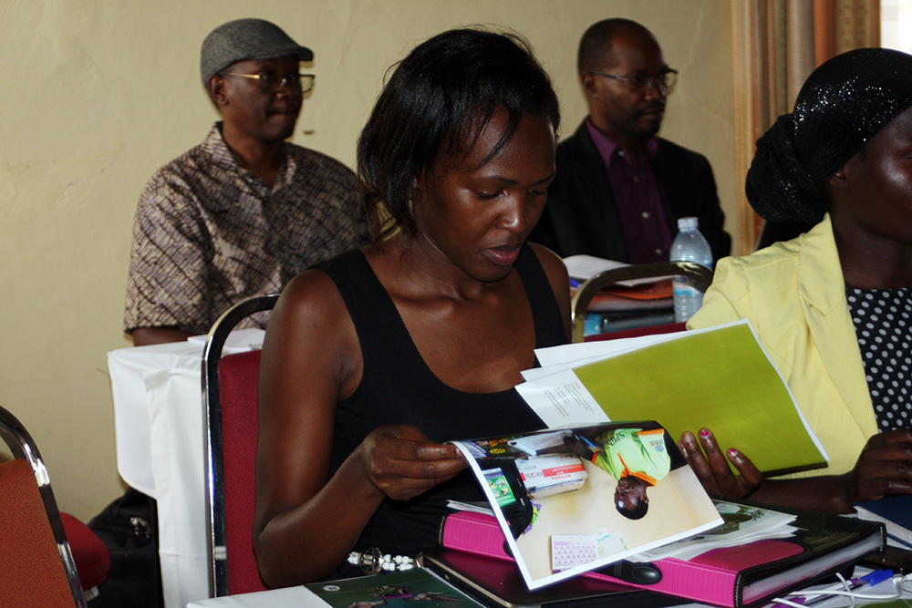 Goretti Kyebajia, a health facility staff member from Namutumba district, reviews the MNP materials.