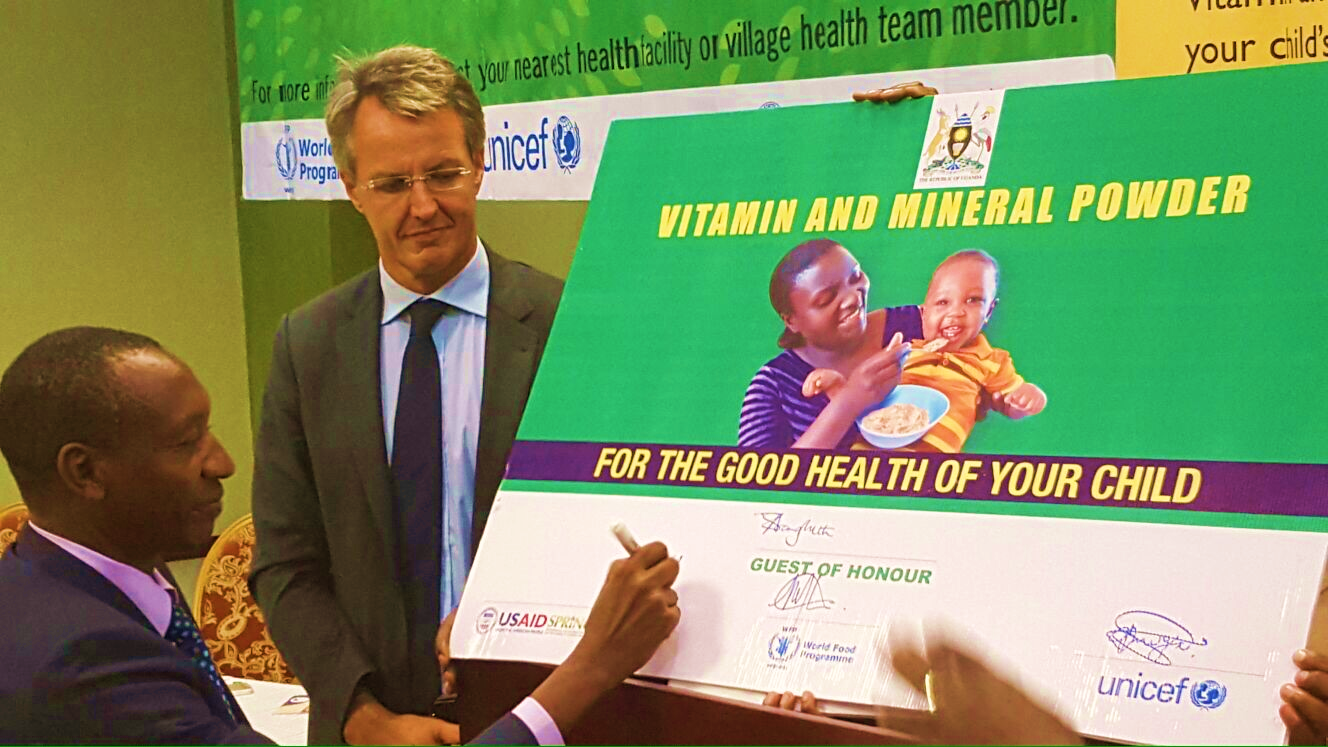 Dr. Boyo signs the commemorative micronutrient powder sachet (Photo credit Abel Muzoora).