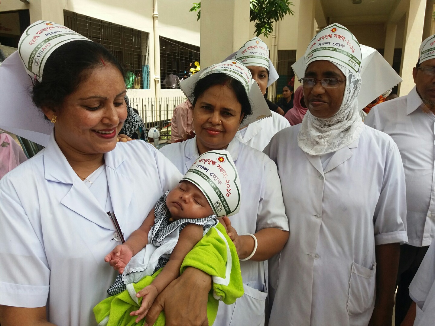 Nurses hold a newborn child in Abhaynagar upazila