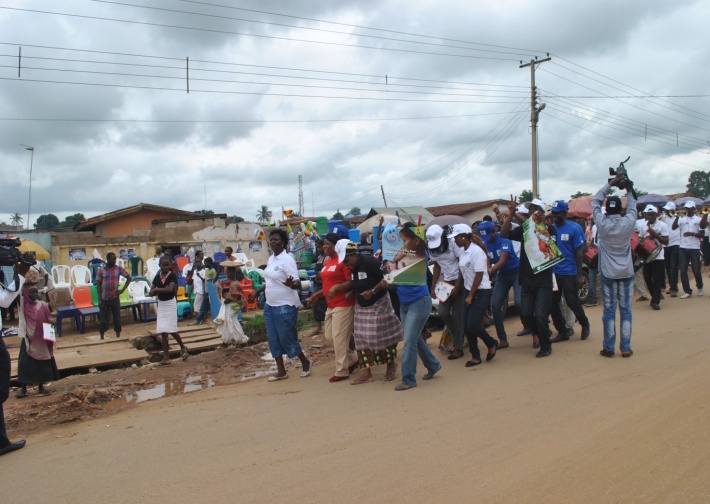 Participants dance and disseminate infant and young child flyers at Kuje Market, in Nigeria in 2014.