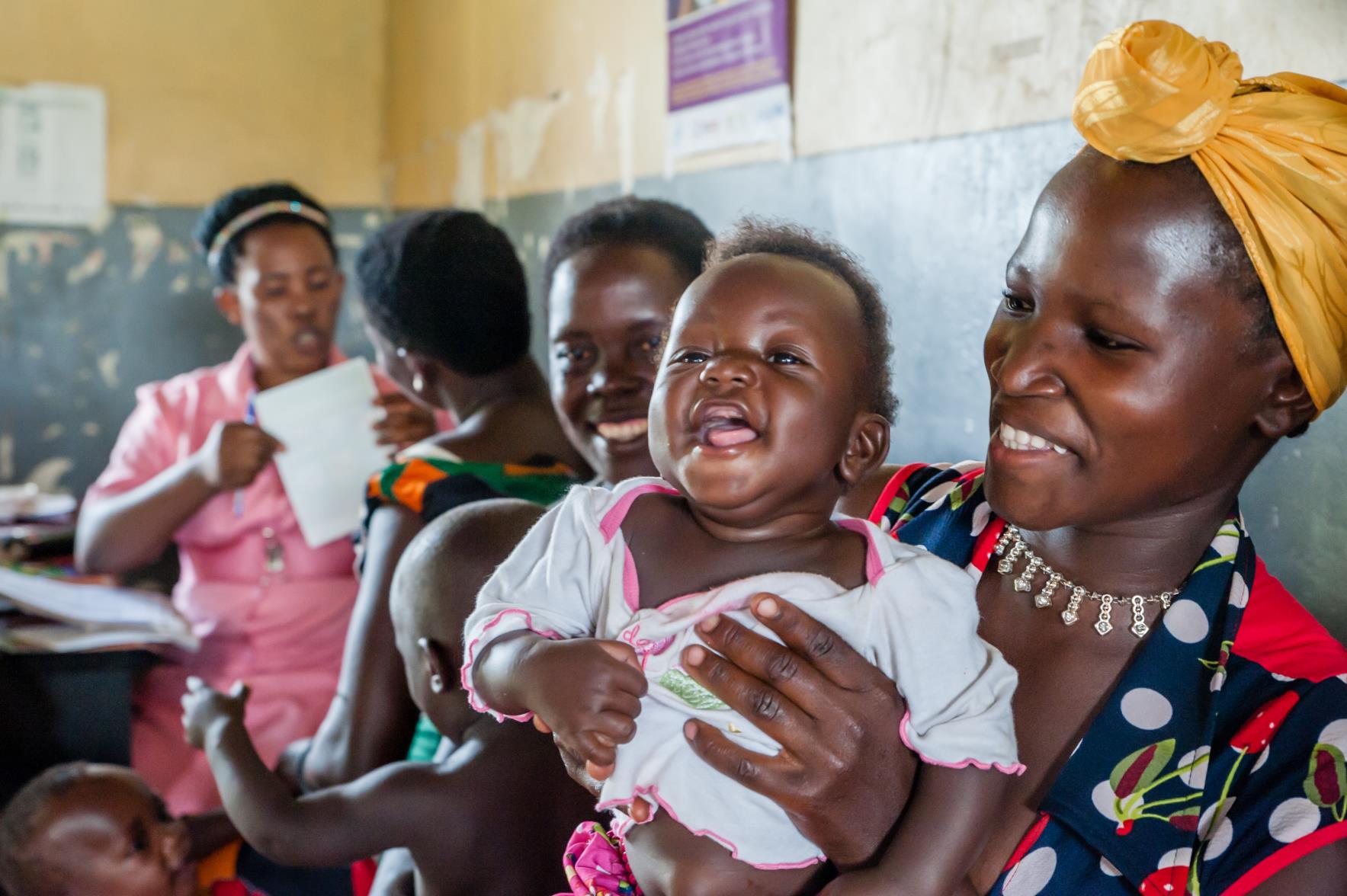 Cover photo: a young mother holding her smiling child in a clinic