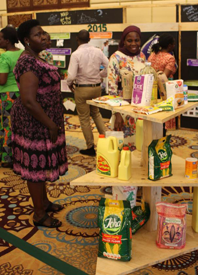 Photo of two women looking at a display table at a event. Caption: 