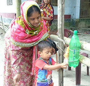 Using a tippy tap in Abhaynagar. Photo courtesy SPRING/Bangladesh.