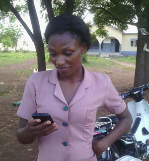 Faustina Kiisi, a community health nurse at Tolon Health Center, reaches out to her colleagues on WhatsApp.