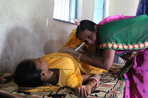 Health worker examining pregnant woman