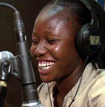 Photo of woman smiling at a microphone