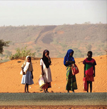 Photo of several people standing by the side of a road