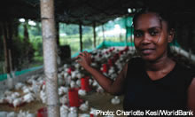 Woman shows her chickens to the camera - source: Charlotte Kesl/World Bank
