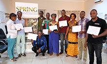 All of the workshop participants display their completion certificates. 