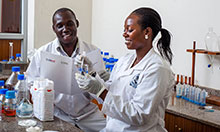 Thomas Okoth and Justine Nabuuma of Uganda Industrial Research Institute (UIRI) perform an iron spot test on maize flour, to establish if the flour with the fortification logo is actually fortified. 
